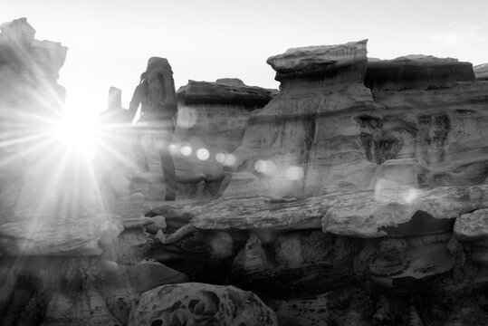 Backpacker Hiking in Bisti De Na Zin Wilderness Area New Mexico Badlands at Sunrise Black and White