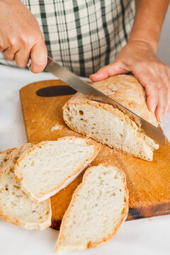 Senior Woman Cutting Stale Bread for the Tuscan Tomato Bread Soup, Pappa al Pomodoro