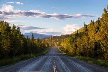 Obraz premium Scenic Road View of Klondike Hwy during a sunny and colorful sunset. Taken North of Whitehorse, Yukon, Canada.