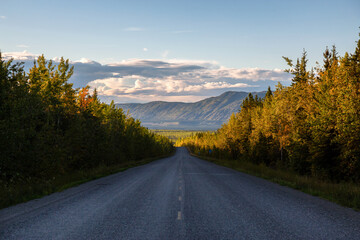 Scenic Road View of Klondike Hwy during a sunny and colorful sunset. Taken North of Whitehorse, Yukon, Canada.