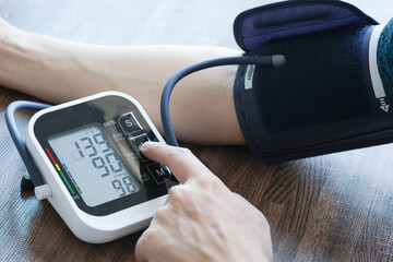 Man check blood pressure monitor and heart rate monitor with digital pressure gauge. Health care and Medical concept