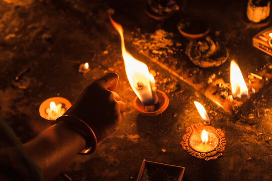 Hand light a candle in a temple