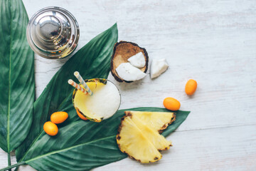pina colada from above with fruits and a stainless steel shaker