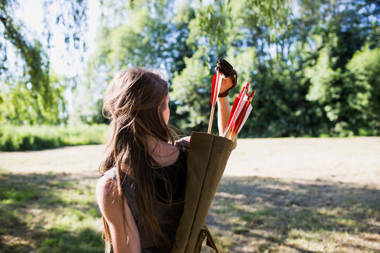 Woman takes an arrow from the quiver