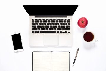 Top view of workspace with apple and a cup of coffee on white background