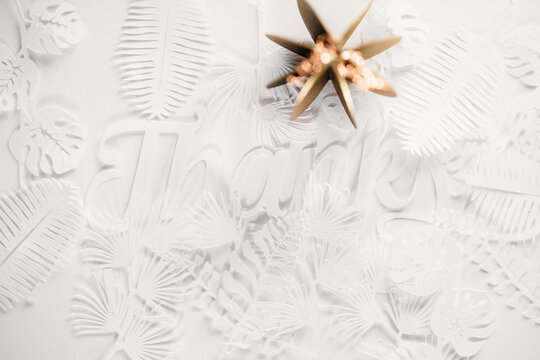 Thanks cut out of paper with a golden paper pumpkin that looks like a flower