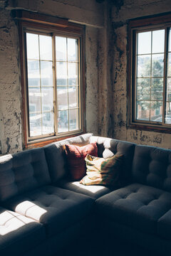 Cozy Corner Couch Near Windows In Rustic Warehouse Attic