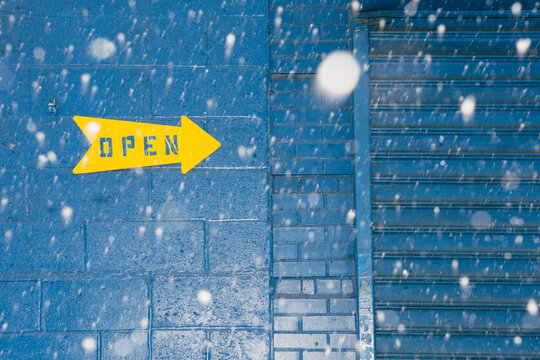 Open sign during snowstorm