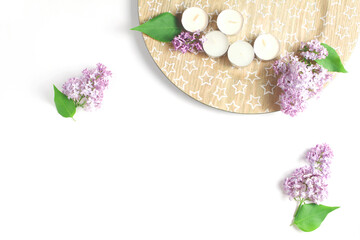 minimalistic composition on a white background. branches of fresh lilac flowers are photographed from the top. flat lay, space for text
