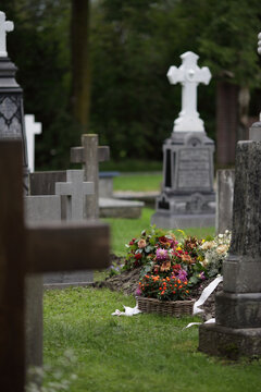 fresh grave with flowers at a cemetery
