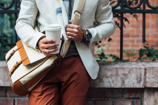 Man Holding a Paper Coffee Cup
