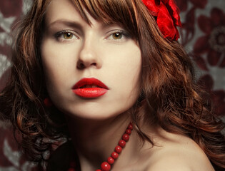 Fototapeta premium Young woman with red lips, close up portrait