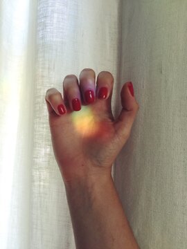 A hand with a rainbow on it