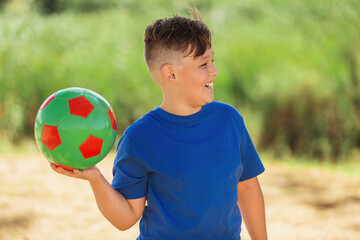child playing and smiling with ball in hand