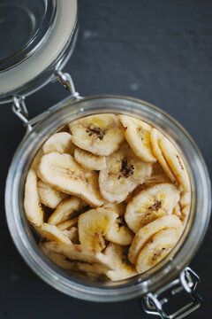 Dried banana: Closeup of an open jar of dehydrated banana slices.