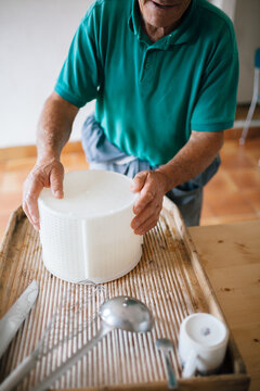 Senior man making homemade cheese