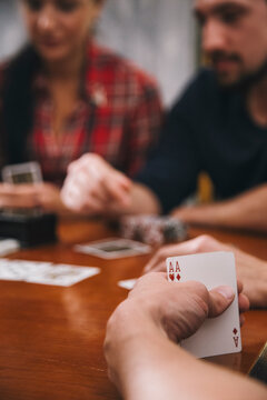 Company of young people playing poker