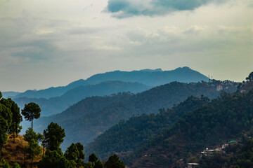 wide shot of beautiful mountains under the cloudy sky, beauty concept. © winistudios