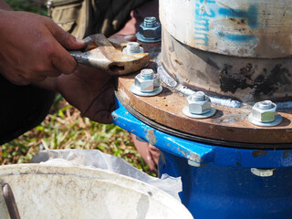 Bolt and nuts installation work on main pipe connections