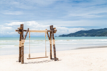 Exotic Tropical Paradise Swings over Crystal Clear Turquoise Blue Ocean.