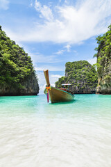 Thai traditional wooden longtail boat and beautiful beach.