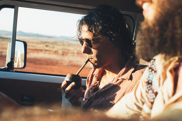 On The Road - Young Latino Man Drinking Mate on Road Trip With Camper Van