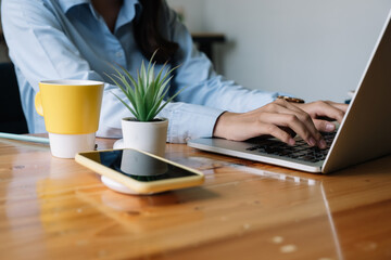 Close up Woman working at home office hand on laptop keyboard