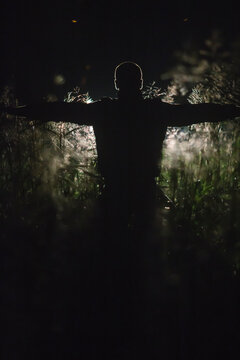 dark silhouette of a man in a field