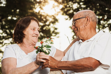 elderly couple looking at each other and talking