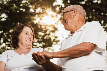 elderly couple looking at each other and talking