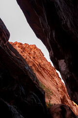 Image of the Khazali canyon, a narrow passage between gigantic red sandstone rocks in Wadi Rum, Jordan. Image shows the outside through the opening on top of the gorge