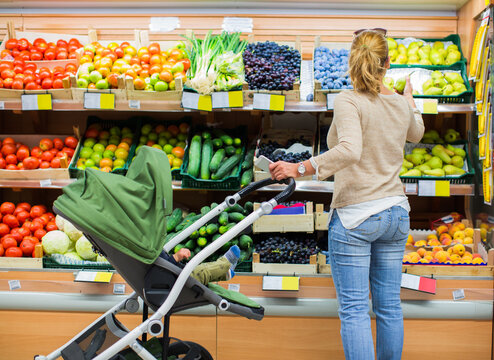 Young Mother Buying Fruits and Veggies
