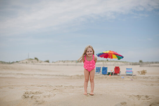Young girl smiling on an empty beach.