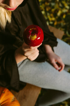 A child holding a toffee apple
