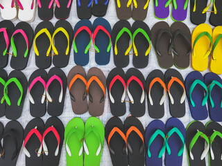 Colorful and comfortable rubber sandals made from rubber for sale at the local market area. Rows of...