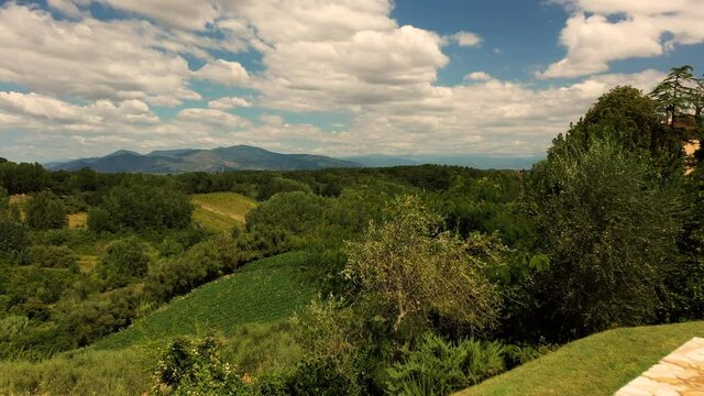 Aerial view of young male adult jumping swimming pool panoramic scene in tuscany italy shot in 4k
