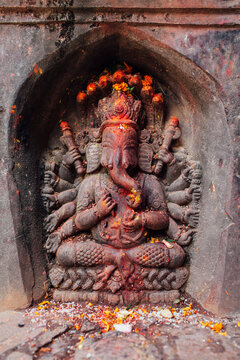 An ancient statue of Lord Ganesh, inside a temple.
