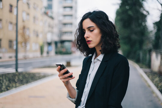 Beautiful woman in suit using her mobile phone
