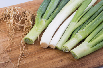 close up image of chopped spring green onions on a white background.