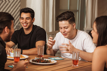 people talking and eating mexican food