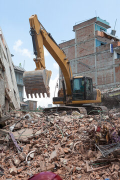 An excavator clearing off debris.