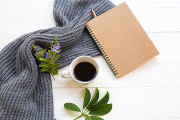 notebook planner for business work with hot coffee espresso ,purple flowers and knitting wool scarf of lifestyle woman relax in winter season arrangement flat lay style on background white 