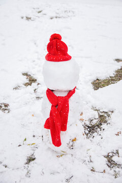 A snowman in red scarf and hat
