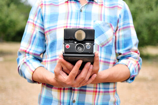 young man with an old camera - Powered by Adobe