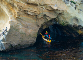 Kayakers Exploring Sea Caves on California Coast
