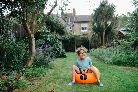 Boy pulling silly face on space hopper