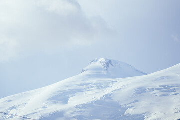 Fototapeta na wymiar big Elbrus mountain in summe on cloudy day
