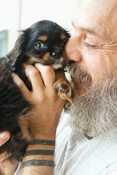 Bearded Man Holding Puppy