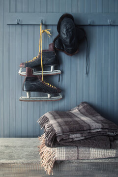 Men's vintage skates and hat hanging on hook