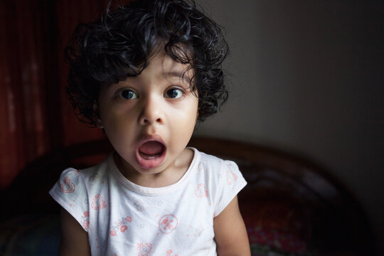 Cute little girl looking in amazement with open mouth